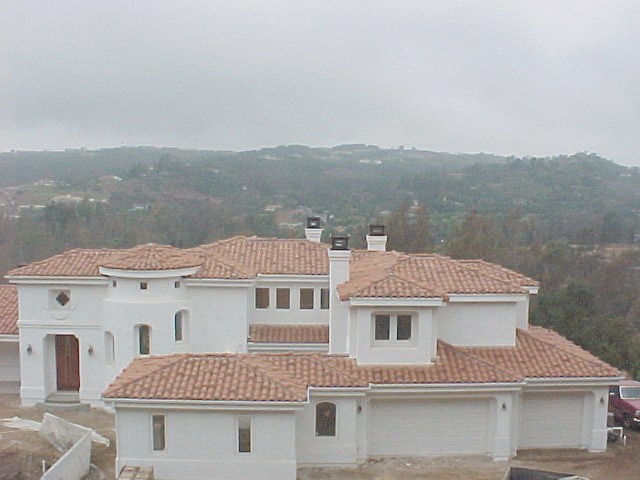 A large Spanish clay tile-roof estate on a Temecula hillside, roofed by Temecula Roofing Co