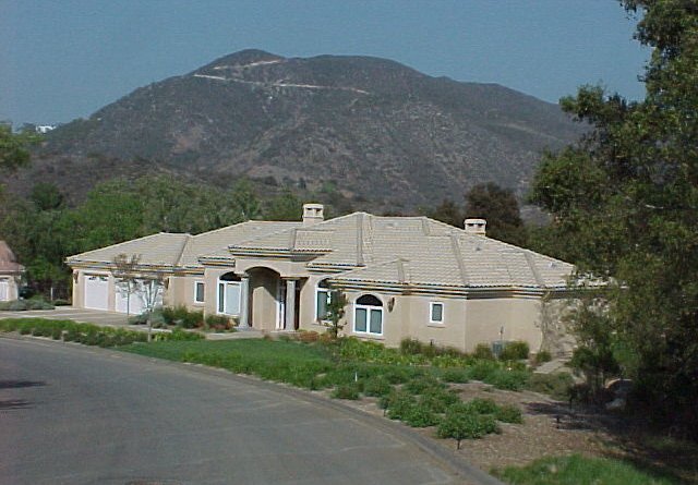 A single-story tile-roof estate below the Temecula hills